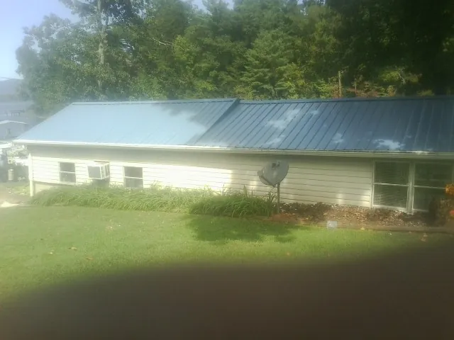 Blue metal roof running the length of a single story home in Astoria